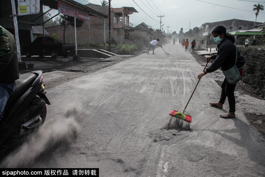 錫納朋火山噴發后 火山灰漫山遍野村民戴口罩清掃